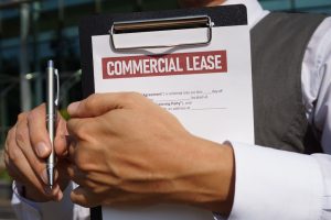 Man holding a Commercial Lease clipboard