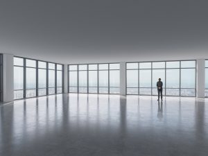 silhouette,of,businessman,against,panoramic,office,window