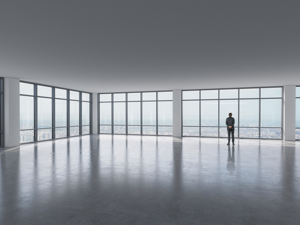 silhouette,of,businessman,against,panoramic,office,window