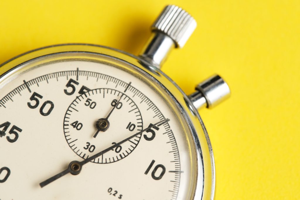 a stop watch on a yellow background